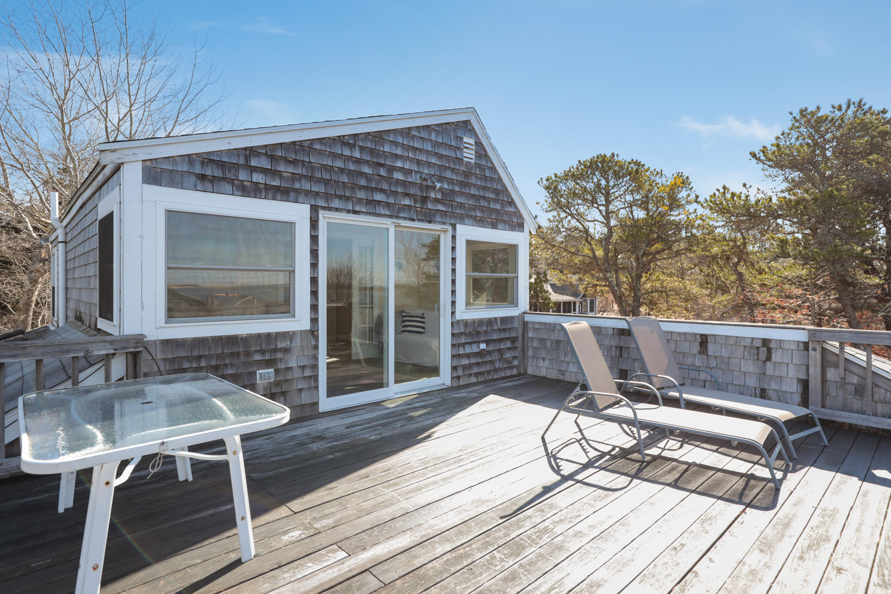 155 Nauhaught Bluff Road Wellfleet, MA 02667 - Photo 25 of 53 a view of balcony with chairs and wooden fence