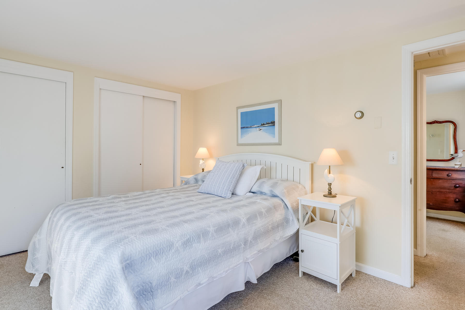 155 Nauhaught Bluff Road Wellfleet, MA 02667 - Photo 27 of 53 a bedroom with a bed and a lamp