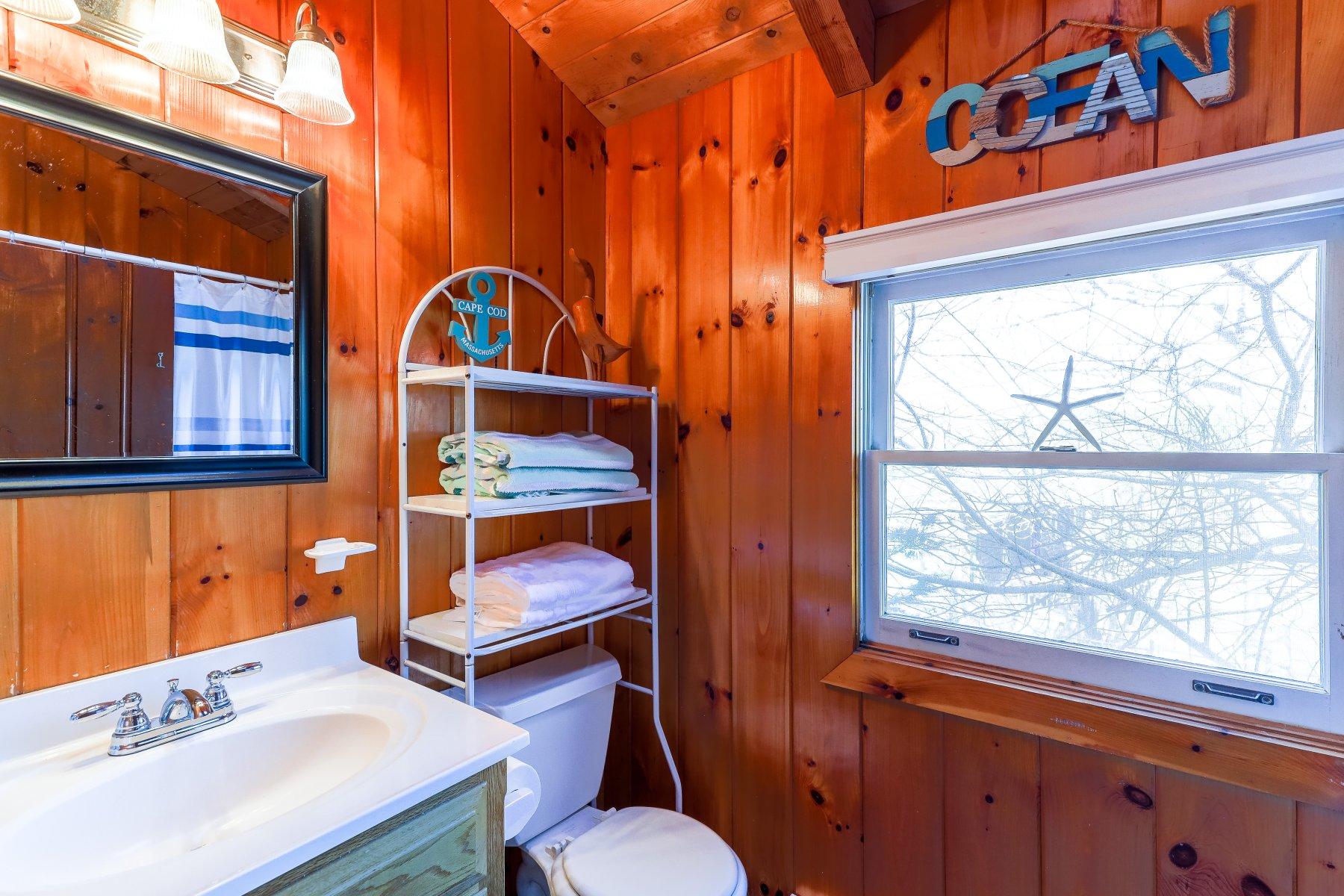 155 Nauhaught Bluff Road Wellfleet, MA 02667 - Photo 31 of 53 a bathroom with a sink a toilet and a window