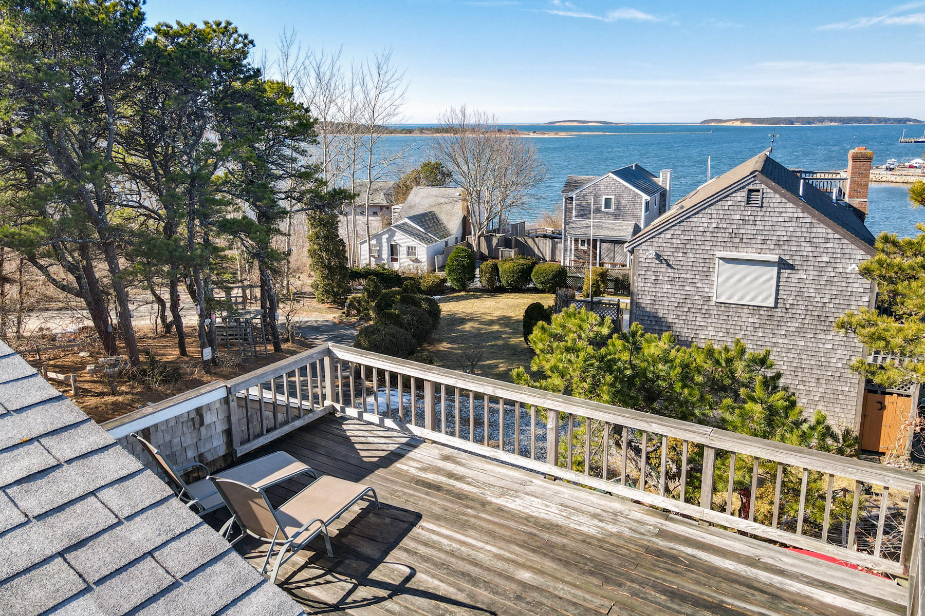 155 Nauhaught Bluff Road Wellfleet, MA 02667 - Photo 39 of 53 a view of a balcony with wooden benches
