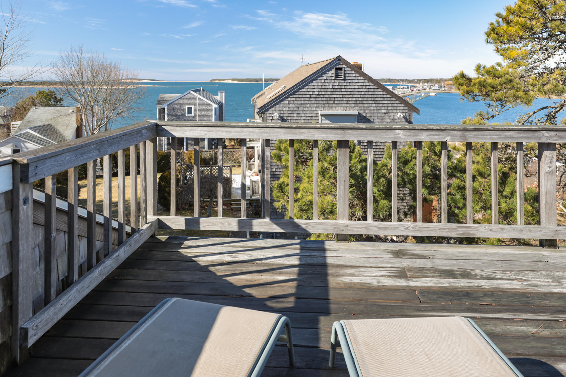 155 Nauhaught Bluff Road Wellfleet, MA 02667 - Photo 7 of 53 a view of a brick house with a large window