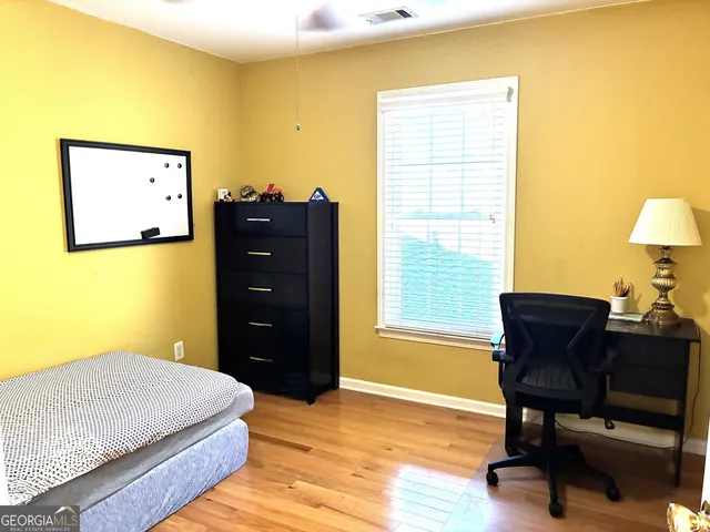 a bedroom with a bed and a dresser