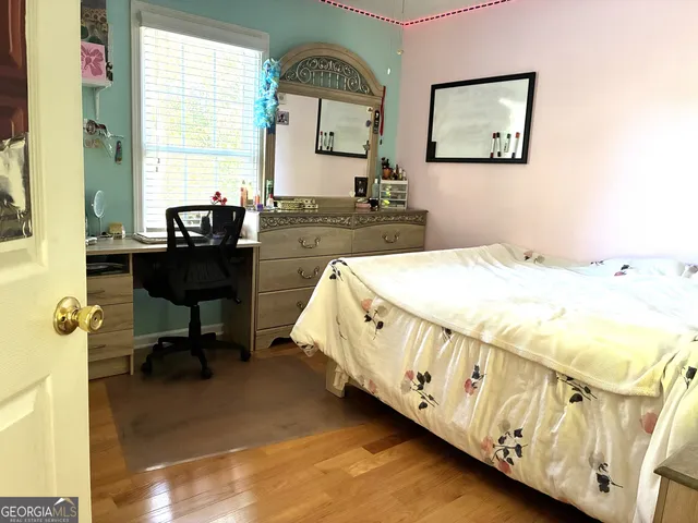 a bed room with a bed mirror table and a window