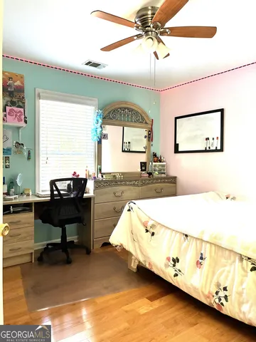 a living room with a bed furniture and a large window