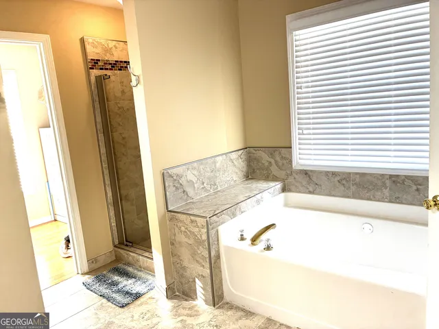 a bathroom with a tub and a shower