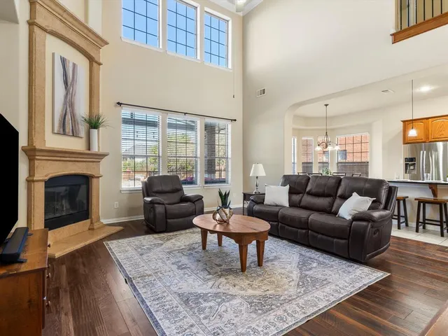 a living room with furniture a fireplace and a table