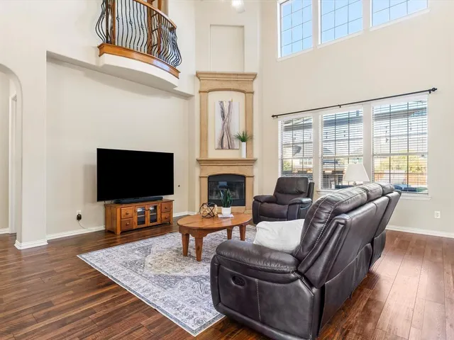 a living room with furniture a flat screen tv and a fireplace