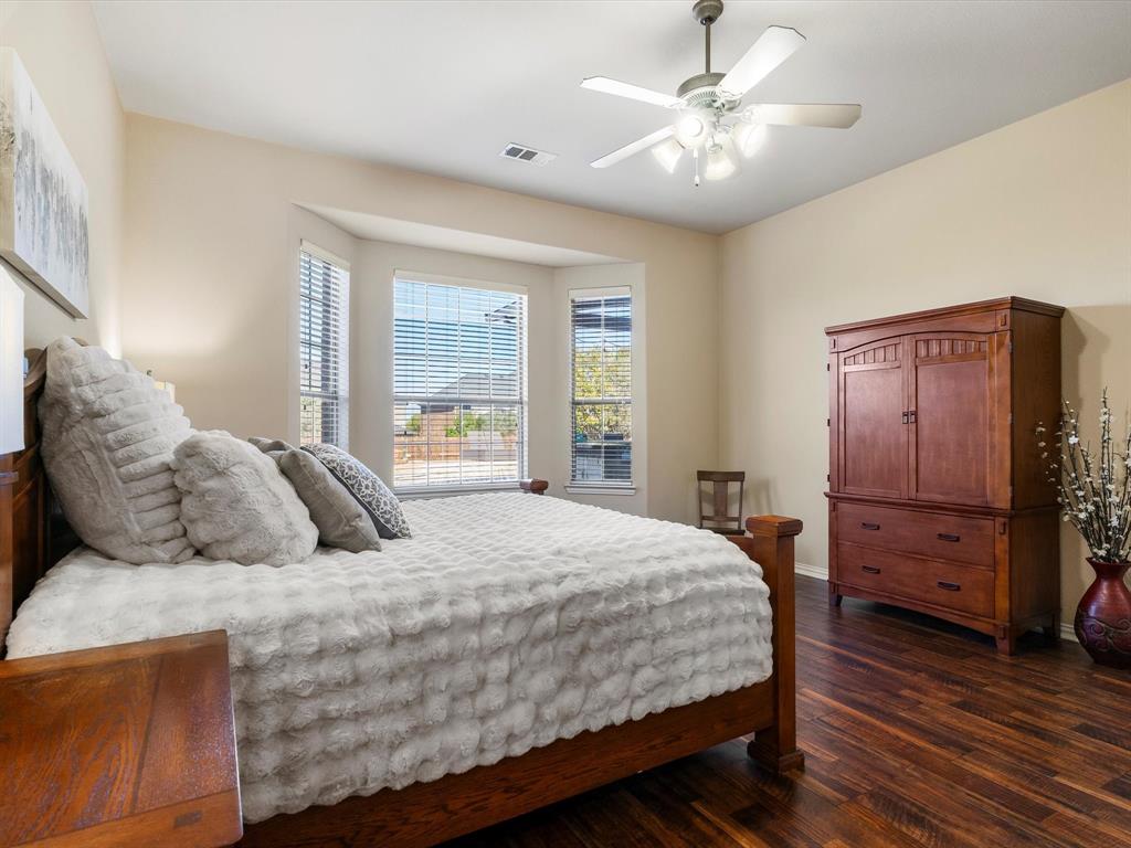 5365 Royal Lytham Road Fort Worth, TX 76244 - Photo 15 of 37 a bedroom with a bed and wooden floor