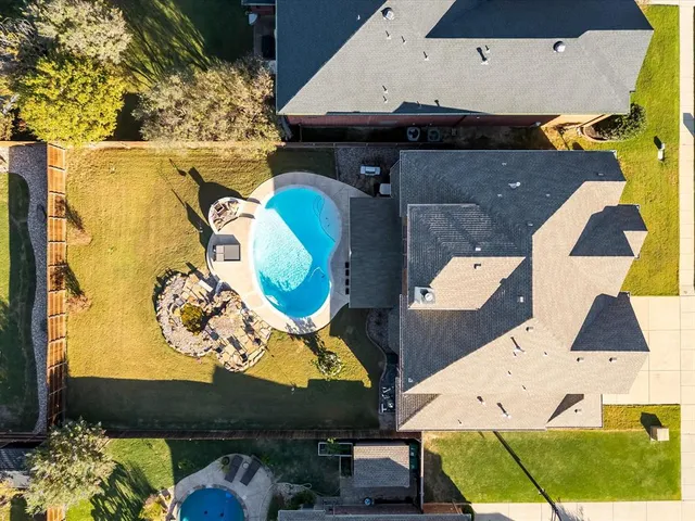 an aerial view of a house with a swimming pool