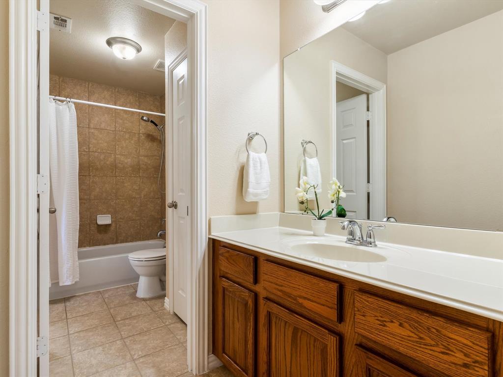 5365 Royal Lytham Road Fort Worth, TX 76244 - Photo 22 of 37 a bathroom with a sink a toilet and shower