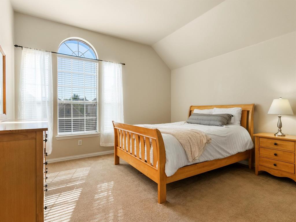 5365 Royal Lytham Road Fort Worth, TX 76244 - Photo 24 of 37 a spacious bedroom with a bed and a window