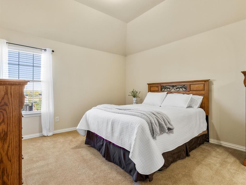 5365 Royal Lytham Road Fort Worth, TX 76244 - Photo 25 of 37 a bedroom with a bed and a cabinets