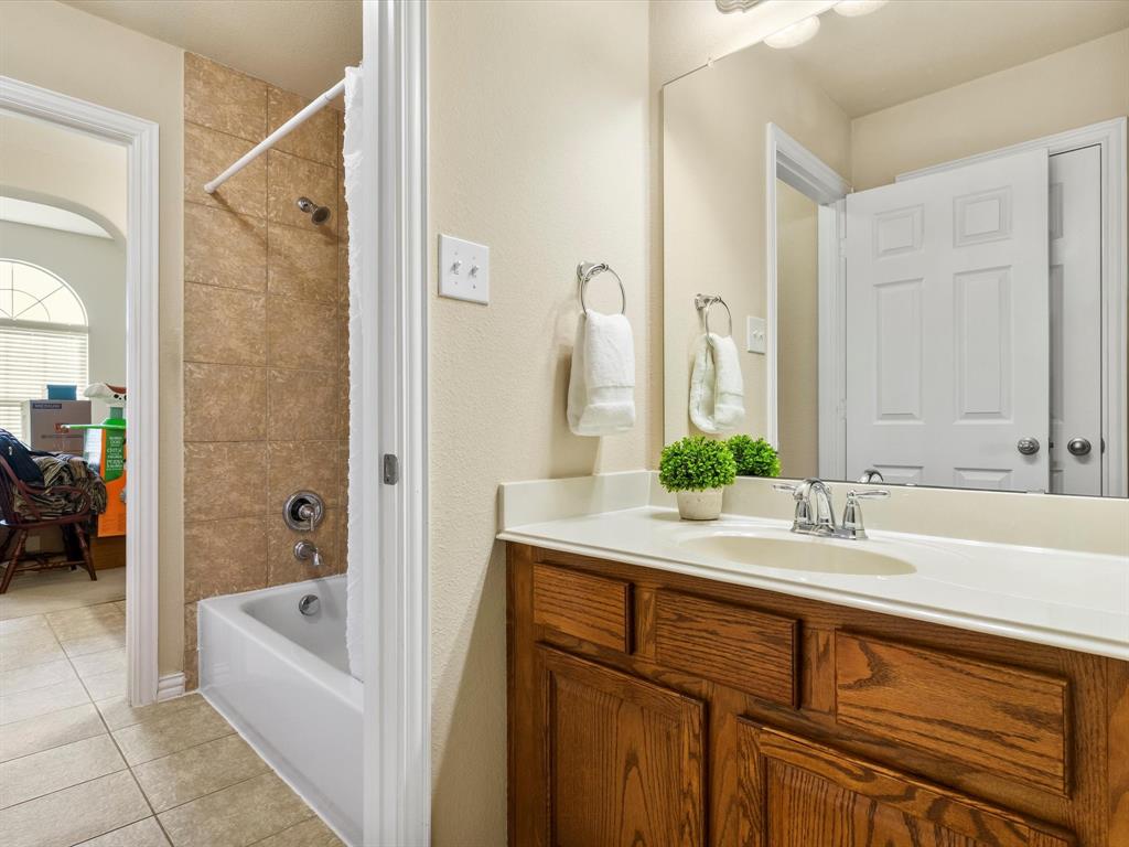 5365 Royal Lytham Road Fort Worth, TX 76244 - Photo 28 of 37 a bathroom with a bathtub and a sink