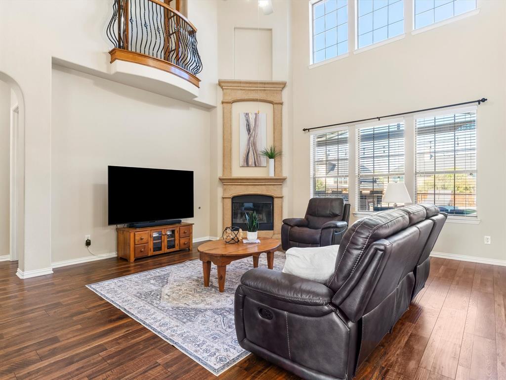 5365 Royal Lytham Road Fort Worth, TX 76244 - Photo 10 of 37 a living room with furniture a flat screen tv and a fireplace