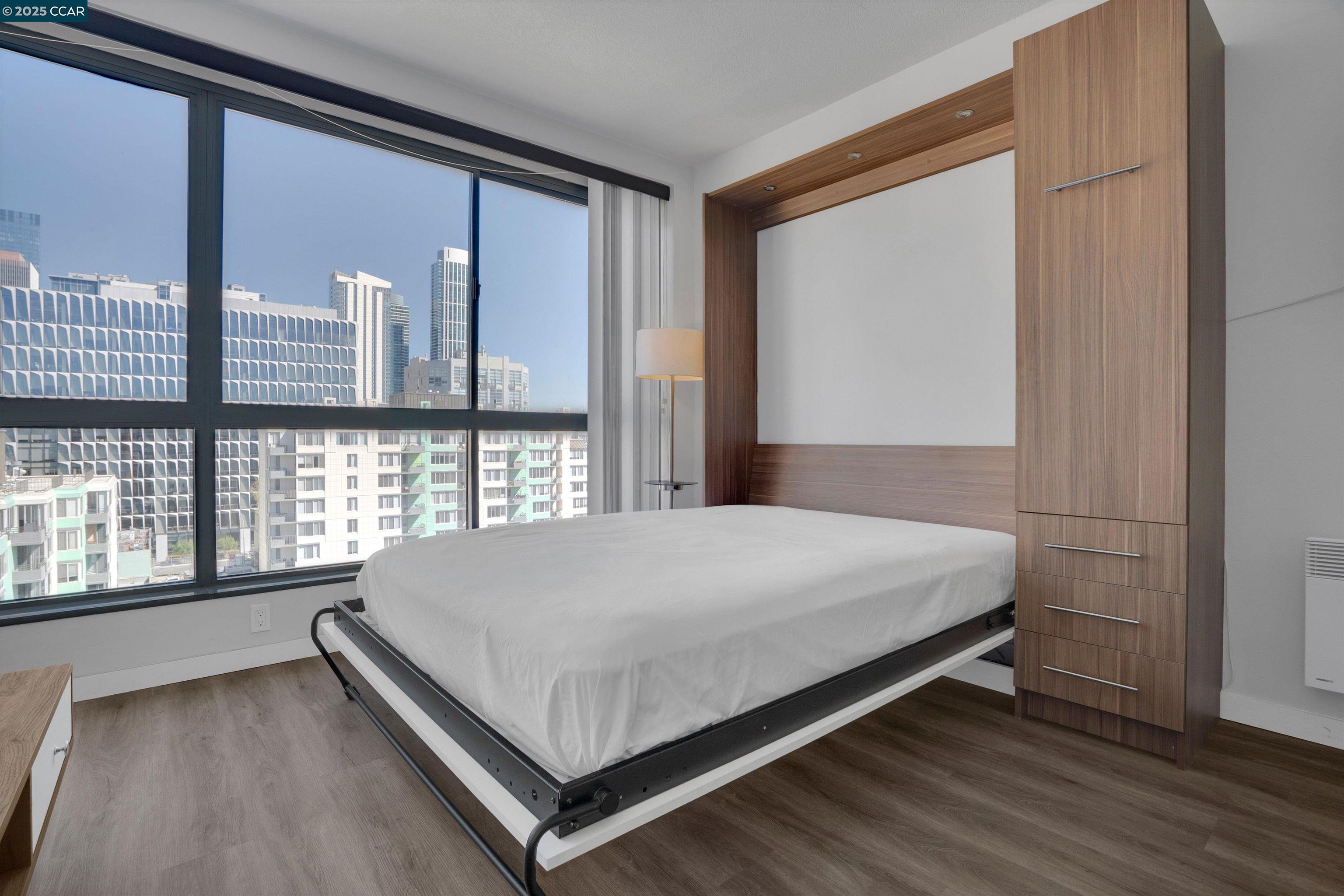 300 3rd Street, Unit 1203 San Francisco, CA 94107 - Photo 11 of 25 a bed sitting in a bedroom next to a window