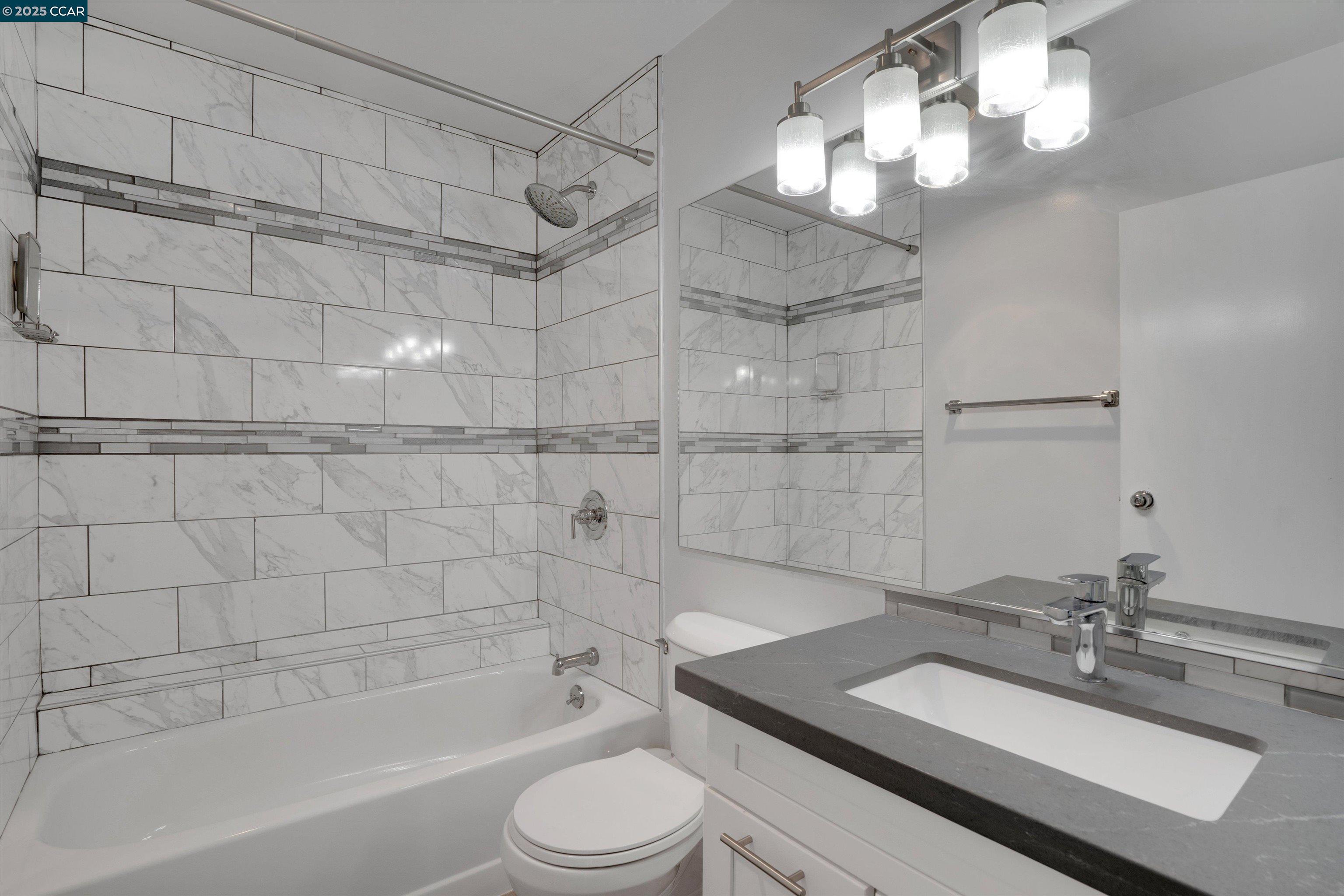 300 3rd Street, Unit 1203 San Francisco, CA 94107 - Photo 12 of 25 a bathroom with a sink a toilet and shower