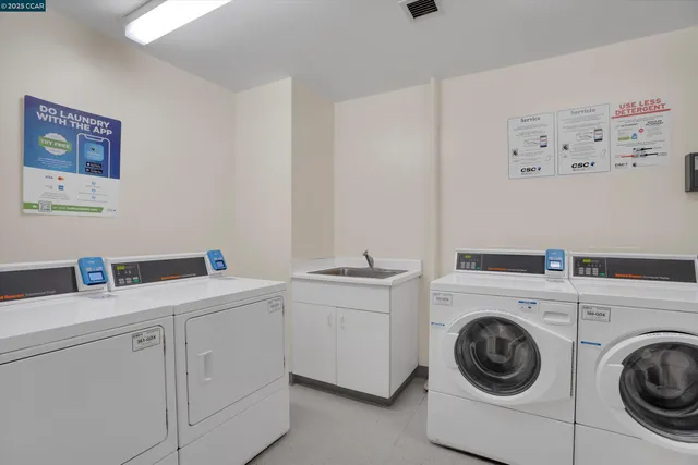 a utility room with sink dryer and washer