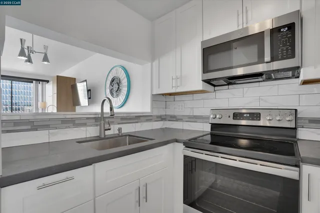a kitchen with a stove microwave and sink