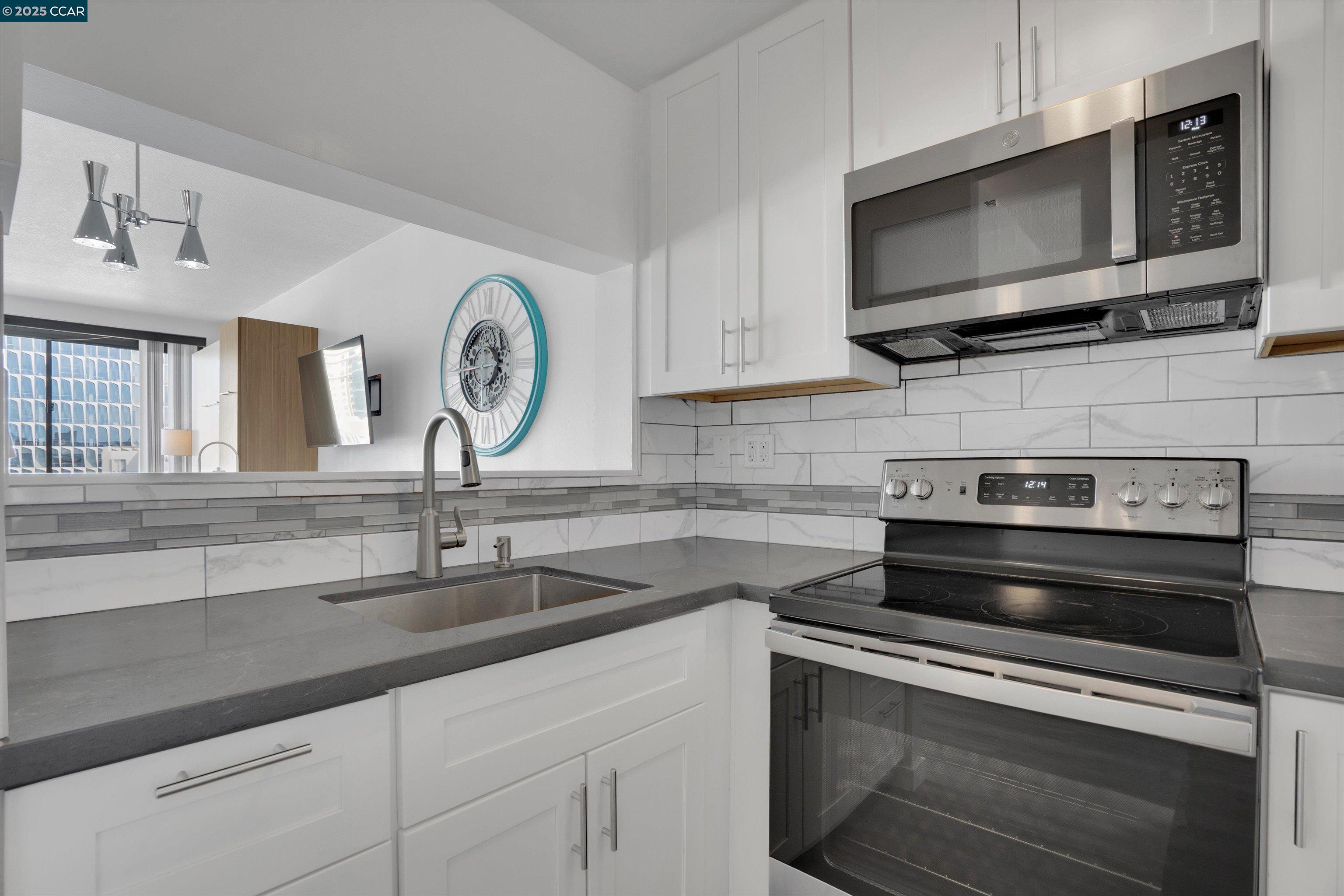 300 3rd Street, Unit 1203 San Francisco, CA 94107 - Photo 3 of 25 a kitchen with a stove microwave and sink