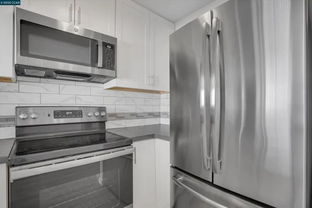 a view of a kitchen with appliances
