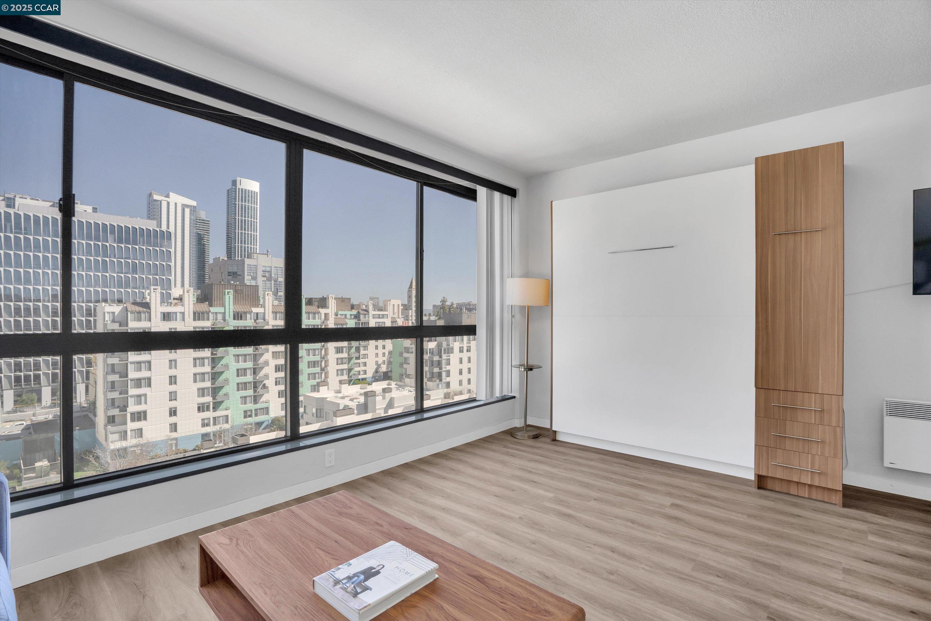 300 3rd Street, Unit 1203 San Francisco, CA 94107 - Photo 10 of 25 a view of an empty room with wooden floor and windows