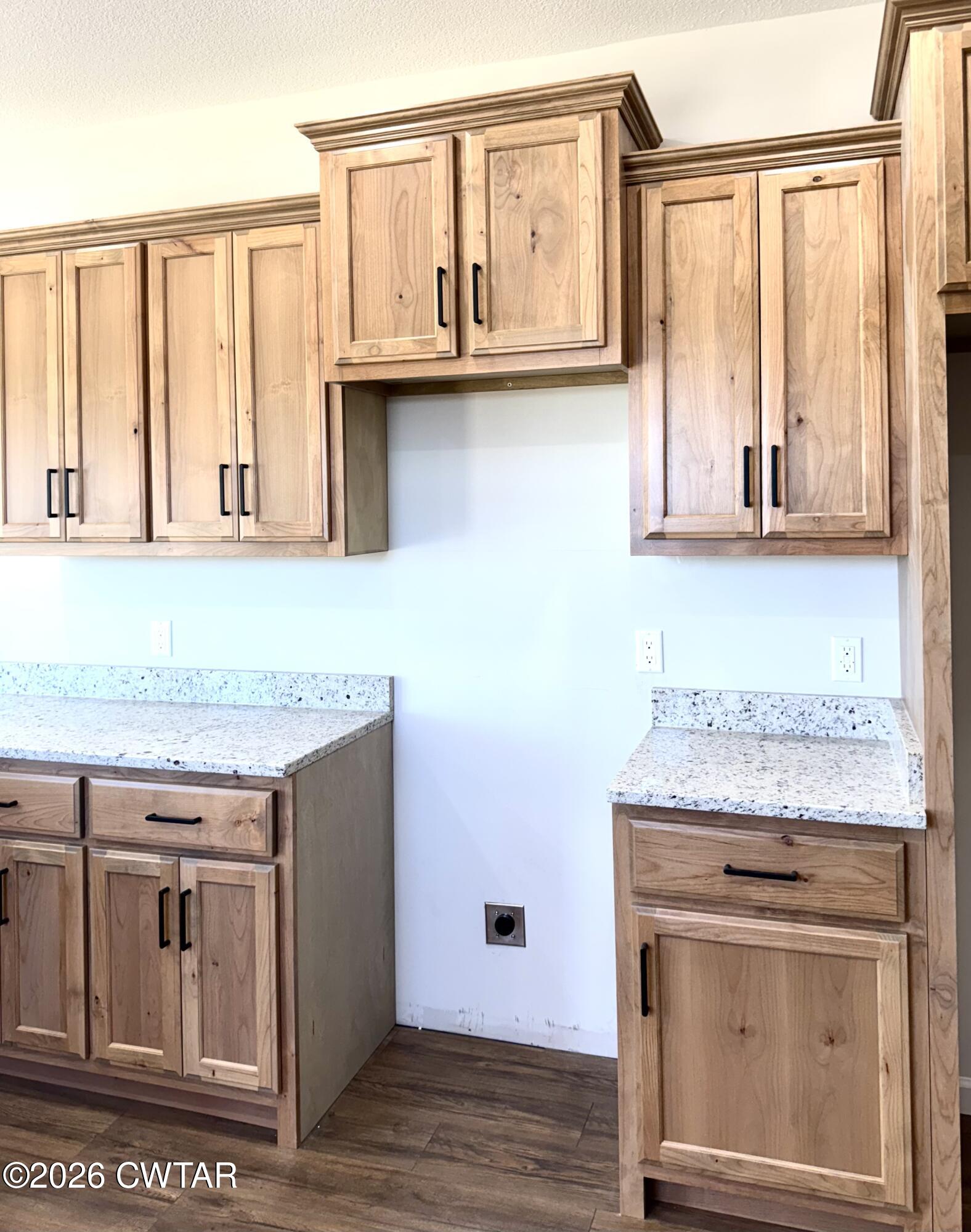 1380 Bonicord Road Dyersburg, TN 38024 - Photo 2 of 10 a kitchen with granite countertop a stove and a microwave