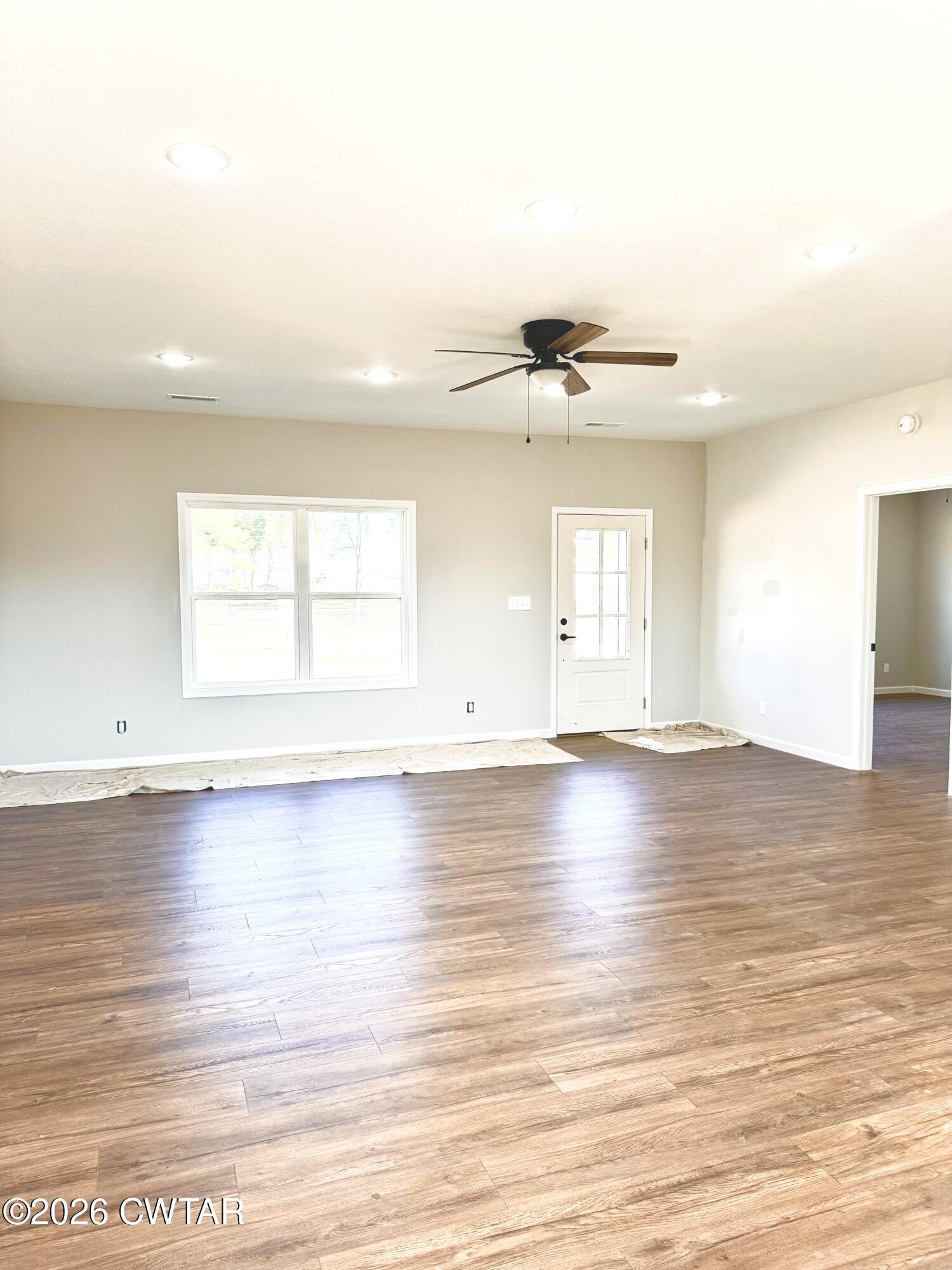 1380 Bonicord Road Dyersburg, TN 38024 - Photo 4 of 10 an empty room with wooden floor and windows