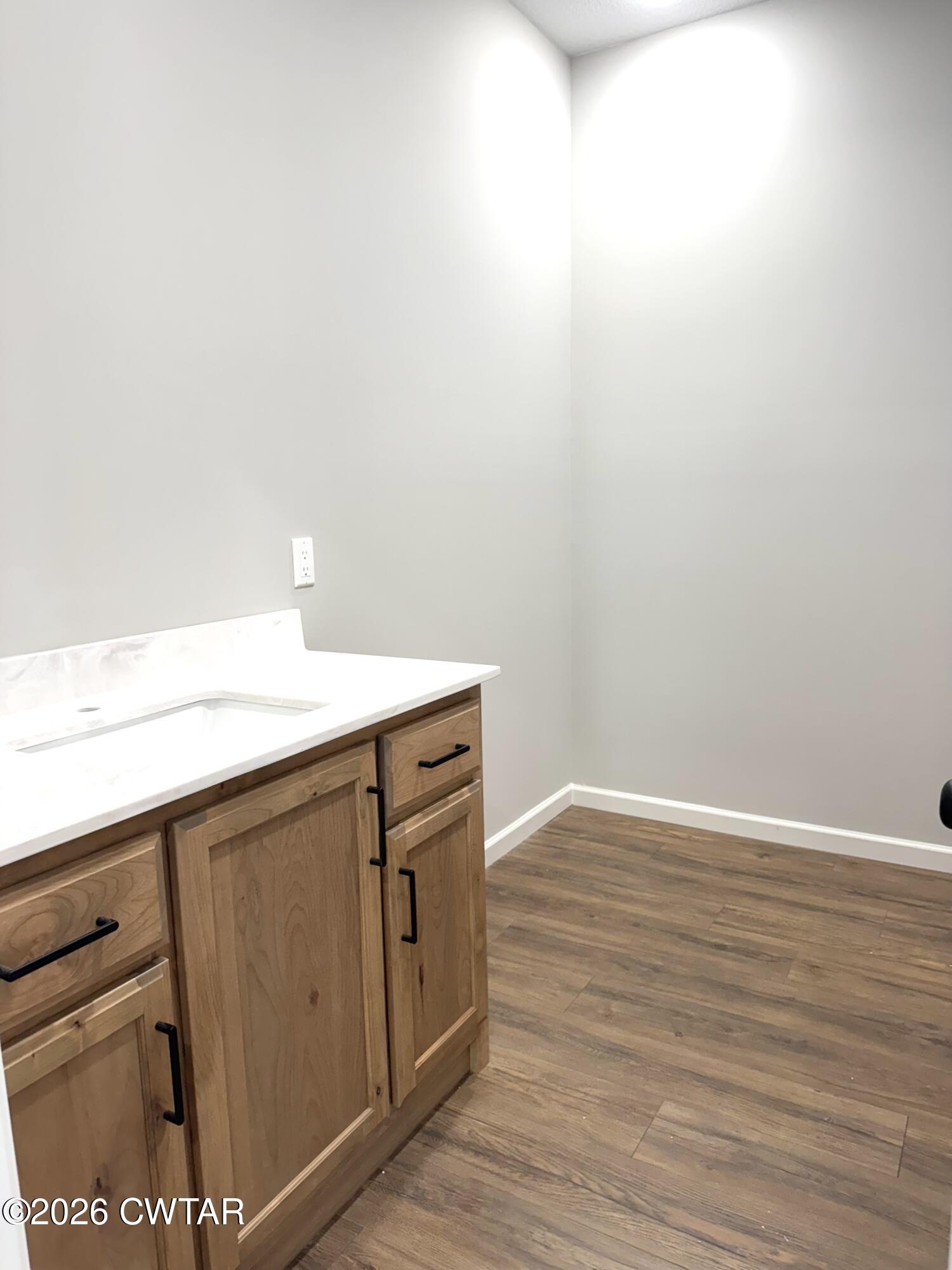 1380 Bonicord Road Dyersburg, TN 38024 - Photo 6 of 10 a view of storage and utility room with wooden floor