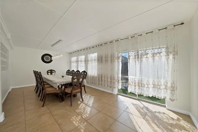 a view of a dining room with furniture and chandelier