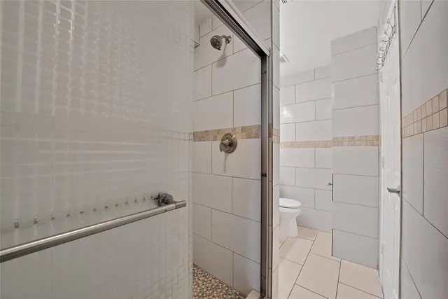 a dining room with furniture and a large window