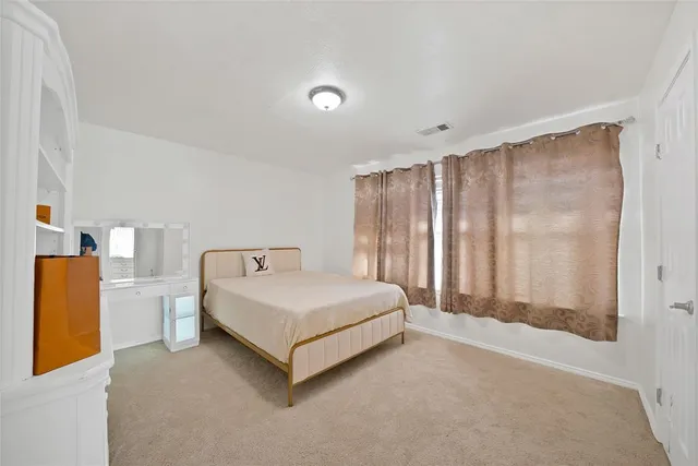 a bed sitting in a room next to a window