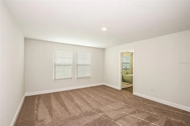 an empty room with a empty space and windows