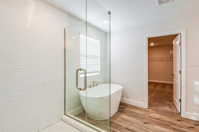 a bathroom with a bathtub and shower