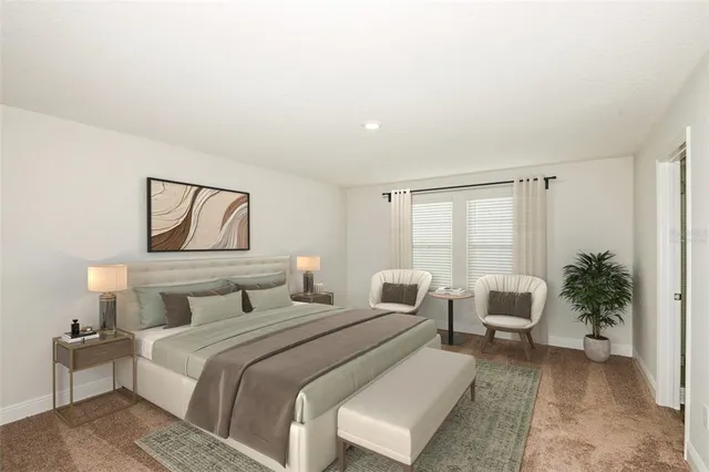 a bedroom with a bed and a potted plant