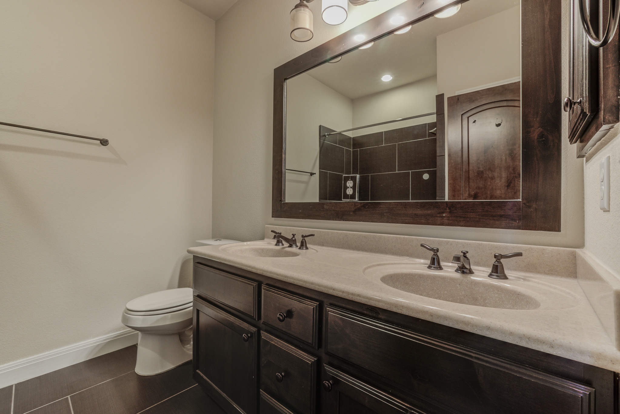 4524 Berkman Drive Austin, TX 78723 - Photo 28 of 38 Double vanity with integrated sinks and dark wood cabinetry