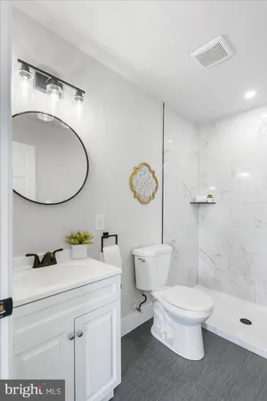 a bathroom with a sink a toilet and a mirror