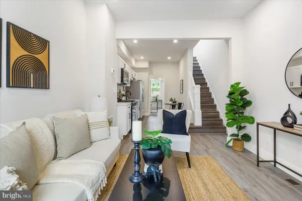 a living room with furniture and a mirror