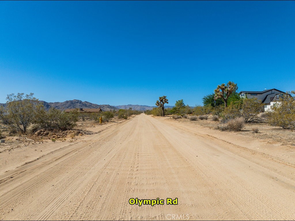60119 Sunny Sands Drive Joshua Tree, CA 92252 - Photo 16 of 21 a view of a road with a snow in the background