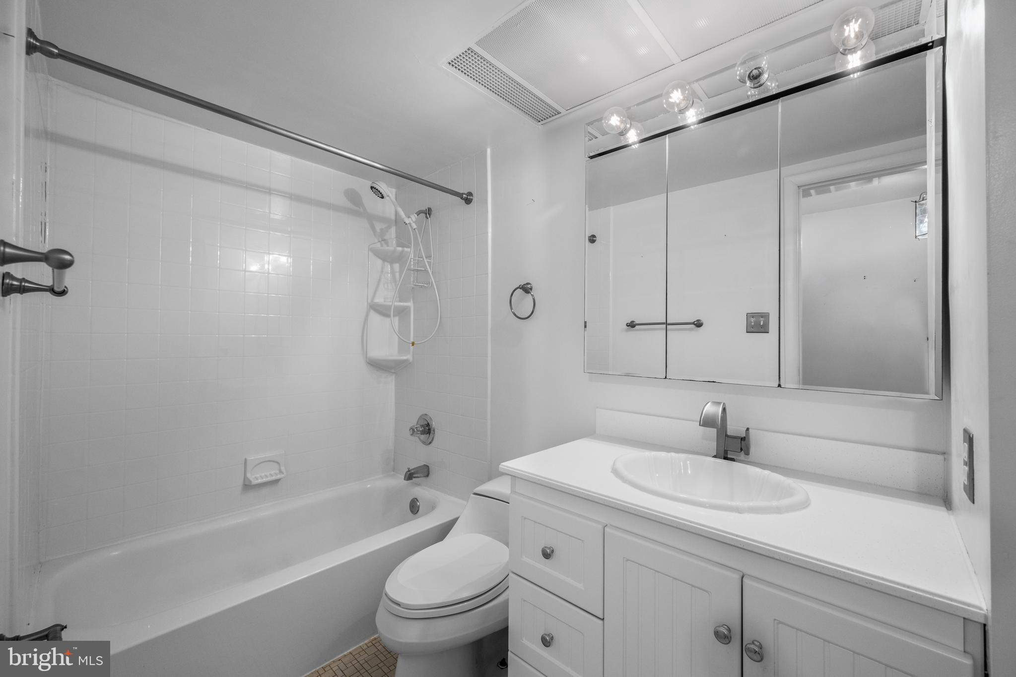 11002 Swansfield Road Columbia, MD 21044 - Photo 12 of 23 a bathroom with a sink a toilet and shower