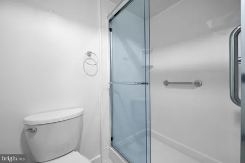 a bathroom with a shower and toilet