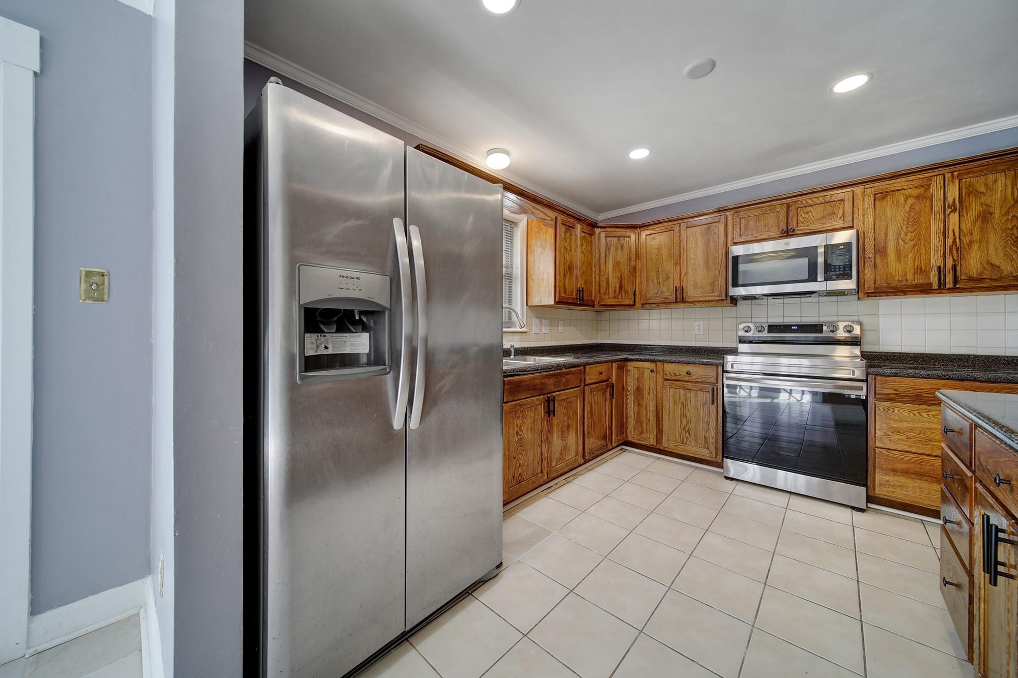 6425 Springfield Drive Charlotte, NC 28212 - Photo 6 of 37 a kitchen with stainless steel appliances granite countertop a refrigerator sink and cabinets
