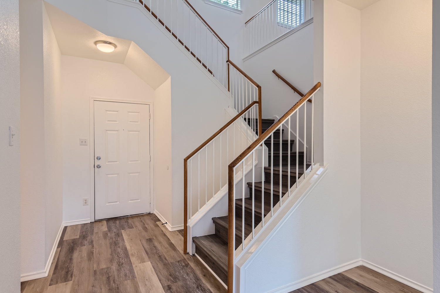 115 Killian Loop Hutto, TX 78634 - Photo 2 of 14 Enter into a bright foyer with rich wood flooring and a graceful staircase leading to the upper levels.