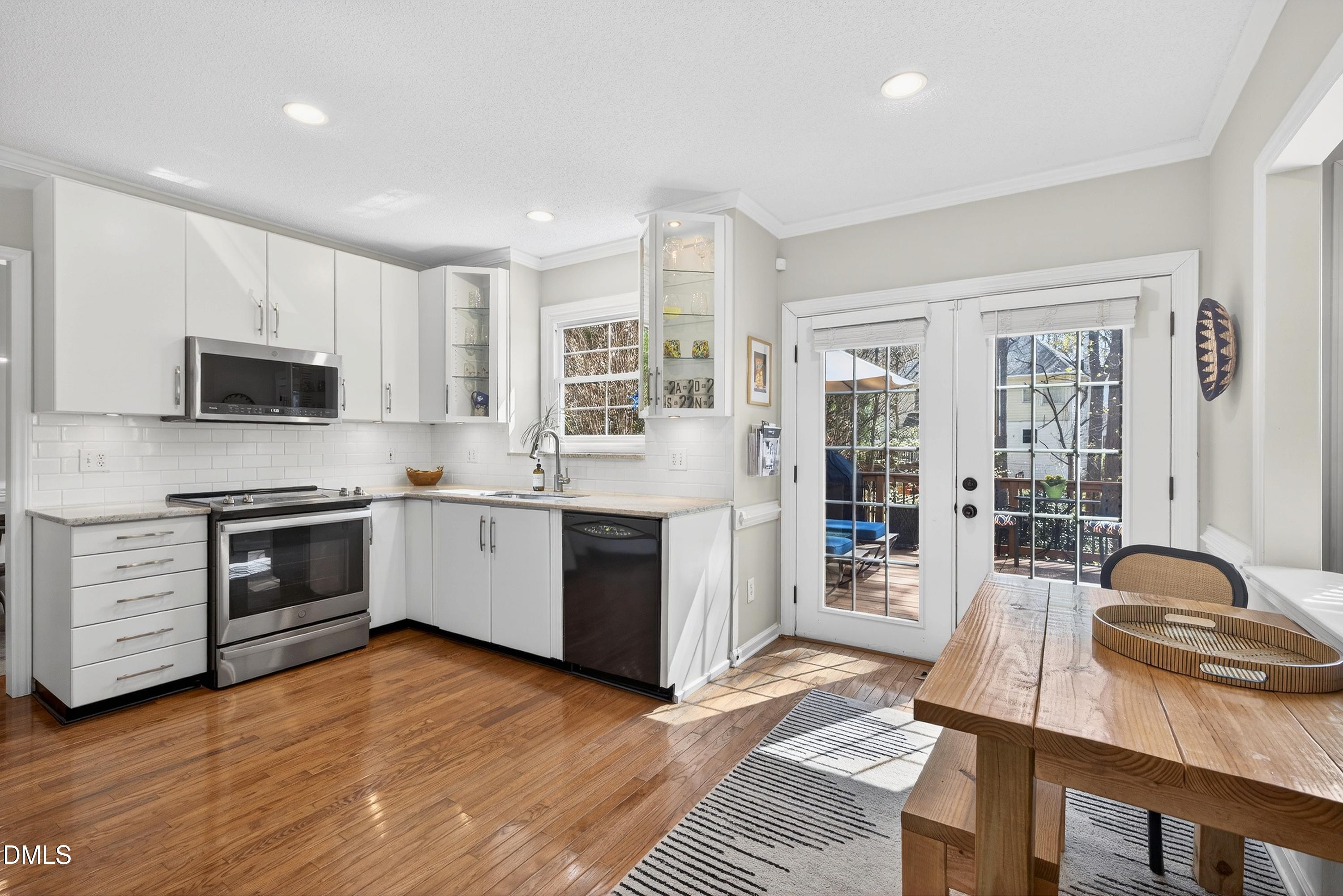 9432 Cartersville Court Raleigh, NC 27617 - Photo 11 of 66 a large kitchen with stainless steel appliances granite countertop a stove and a sink