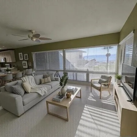 a bedroom with a large bed and a tv on dresser