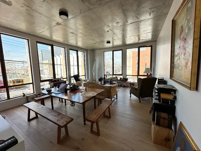 a view of a livingroom with furniture window and wooden floor