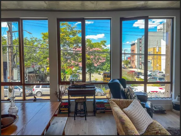 a living room with furniture and a floor to ceiling window