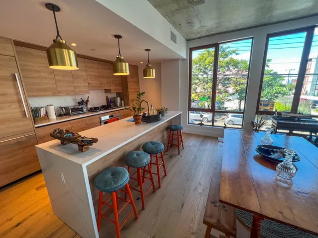 a kitchen with sink stove and wooden floor