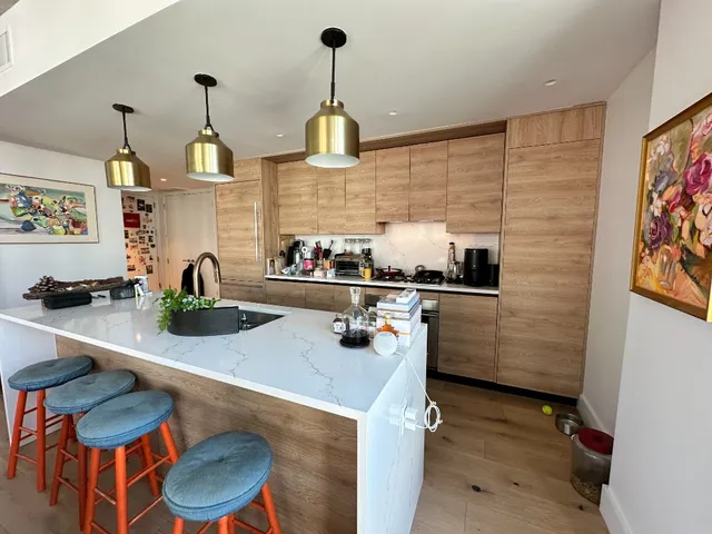 a kitchen with a sink a stove and wooden floor