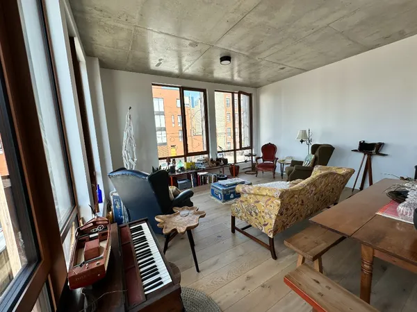 a living room with furniture a rug and a window