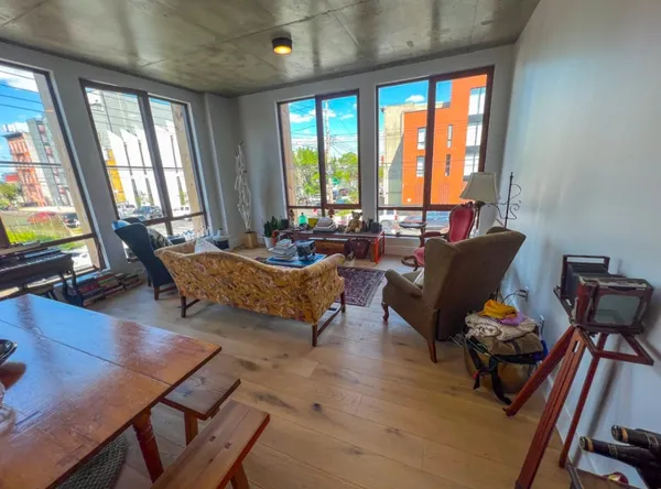 a living room with furniture and floor to ceiling windows